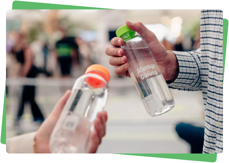 Two people holding cupanion bottles towards the camera