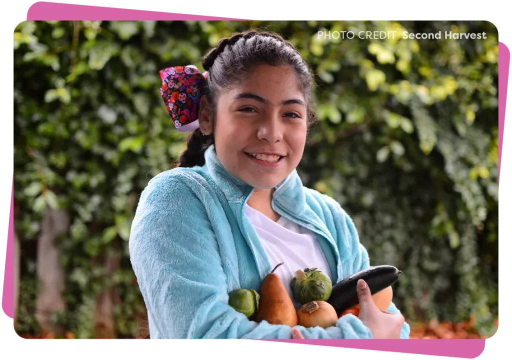 Women holding different vegetables