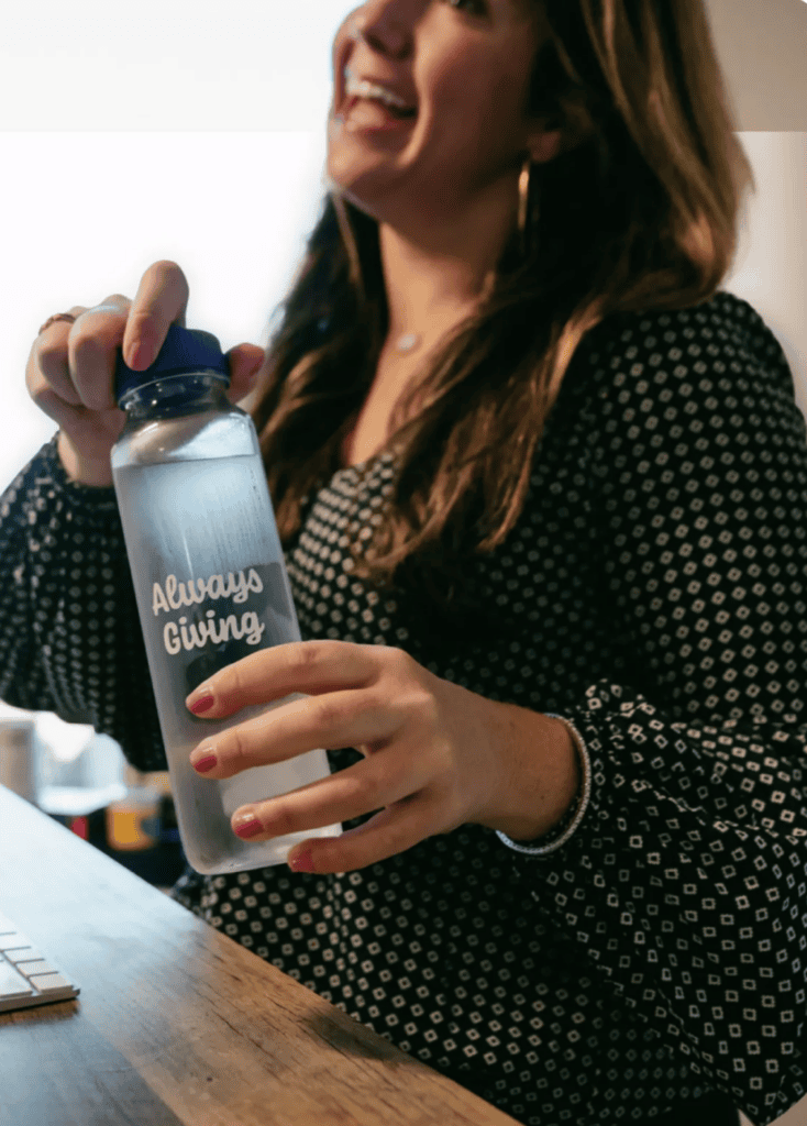 Woman holding cupanion bottle towards camera